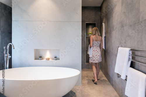 Modern Bathroom With Oval White Freestanding Bath Woman