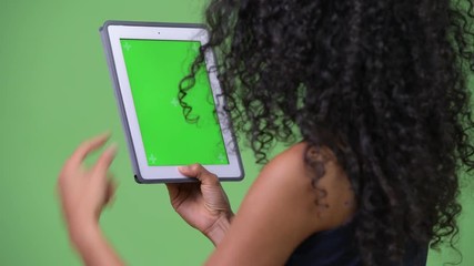 Young beautiful Hispanic businesswoman using digital tablet