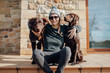 © sosann/Stocksy - Young woman with two brown dogs