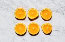 Orange Slices On White Marble
