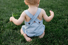 Toddler Playing In The Grass