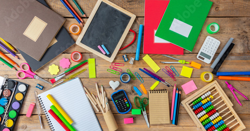 Fotografía Back to school. School supplies on wooden background, top view