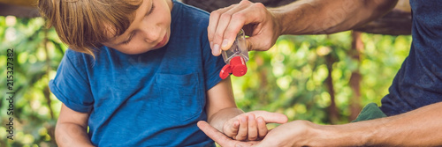 Fotomural Father and son using wash hand sanitizer gel in the park before a snack BANNER,