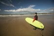 © Wavebreak Media - Surfer with surfboard looking at the sea