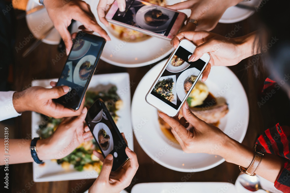 Group of friends going out and taking a photo of Italian food together with mobile phone. - obrazy, fototapety, plakaty 