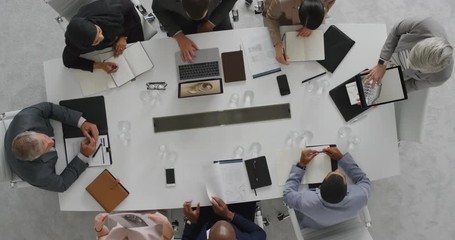 Wall Mural - senior business executives in boardroom meeting sharing wind turbine project development with clients using tablet pc technology corporate leadership team overhead
