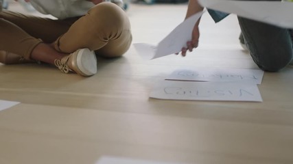 close up young group of diverse web developers people brainstorming ideas for startup business website using paper notes planning design layout on wooden workspace floor