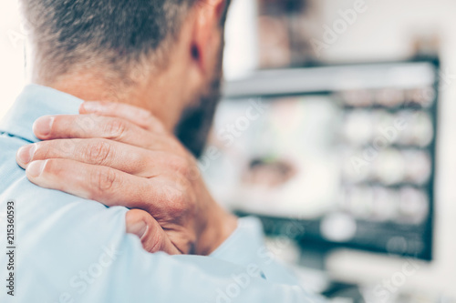 Fotomural Office worker with neck pain from sitting at desk all day