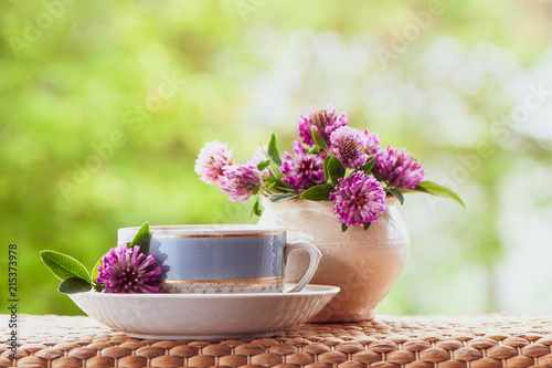 Veautiful Summer Composition Of A Cup Of Tea And Clover Flowers On