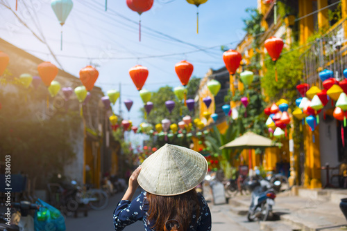 Fotomural Tourist is walking in Old town in Hoi An, Vietnam.