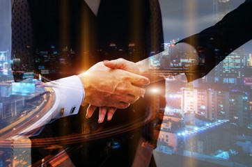 Wall Mural - double exposure of midsection young man handshake with business woman after finishing up meeting with modern city background, partnership, teamwork, connection financial and investment concept