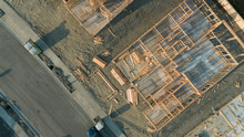Drone Aerial View Of Home Construction Site Foundations And Framing