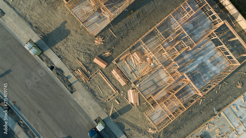 Fotomural Drone Aerial View of Home Construction Site Foundations and Framing