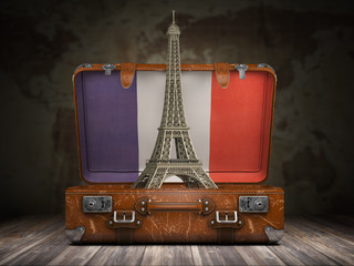 trip to paris. travel or tourism to france concept. eiffel tower andvintage suitcase with flag of fr