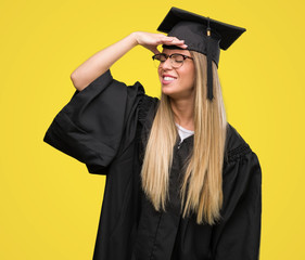 Sticker - Beautiful young woman wearing glasses and graduation robe stressed with hand on head, shocked with shame and surprise face, angry and frustrated. Fear and upset for mistake.