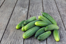 A Lot Of Fresh Green Cucumbers On A Board Rustic Table