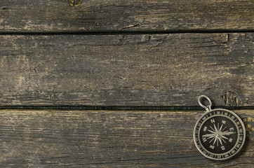 Compass on an old wooden background.