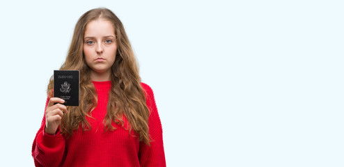 Sticker - Young blonde woman holding passport of United States of America with a confident expression on smart face thinking serious