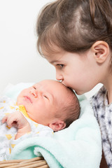 Wall Mural - happy little sister playing hugs his brother baby, boy and girl embraces kisses