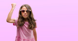 Fototapeta Do pokoju - Brunette hispanic girl wearing sunglasses annoyed and frustrated shouting with anger, crazy and yelling with raised hand, anger concept