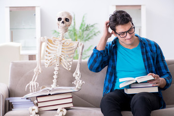 Wall Mural - Student studying with skeleton preparing for exams