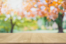 Empty Wood Table Top And Blurred Autumn Tree And Red Leaf Background - Can Used For Display Or Montage Your Products.