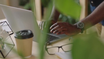 businessman hands typing using laptop keyboard drinking coffee beverage sending email message browsing online internet