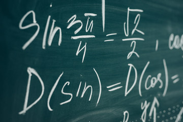 Wall Mural - Trigonometric equation written on the chalkboard. School curriculum.