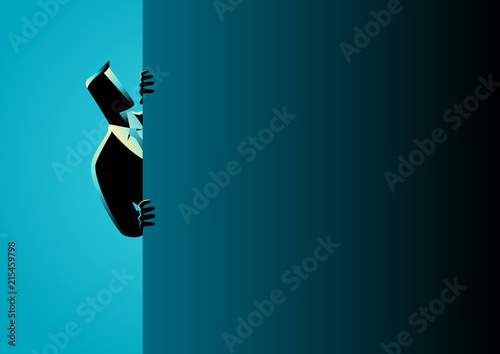 Fotografía Businessman peeking from behind wall