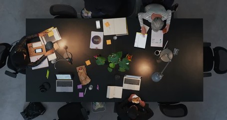 Wall Mural - top view diverse business people in modern boardroom working late interacting planning ambitious market strategy for developing company time lapse