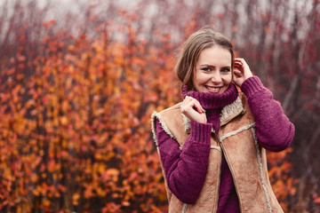 beautiful young woman in a warm sweater in autumn