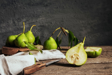 Wall Mural - concept of the harvest of autumn and thanksgiving. Seasonal fruit pear and plum on a wooden table in rustic style with copy space