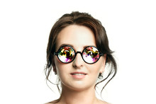 The Head Of A Beautiful Young Woman In Funny Round Holographic Glasses. Isolated On White Background.