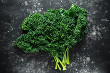 Raw Organic Freshly Picked Green Curly Kale On Black Table