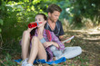 © auremar - young couple backpackers resting in forest