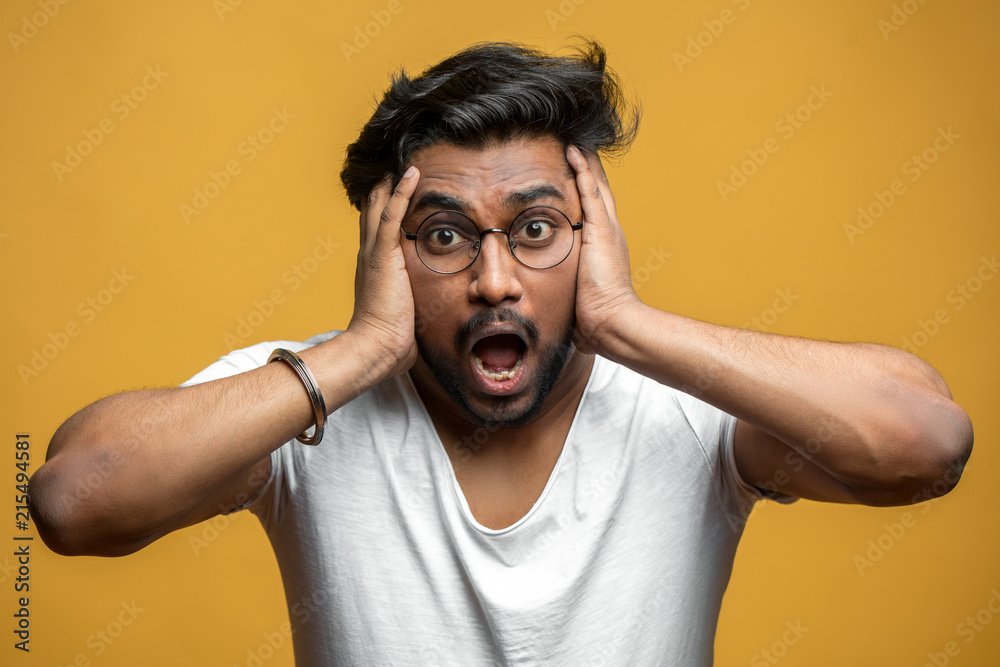 Indian handsome guy expressing shock and despair, touching his head with  hands. man with a lot of problems. male after hearing shocking news,  information. oh, my God!What a shame Stock Photo |