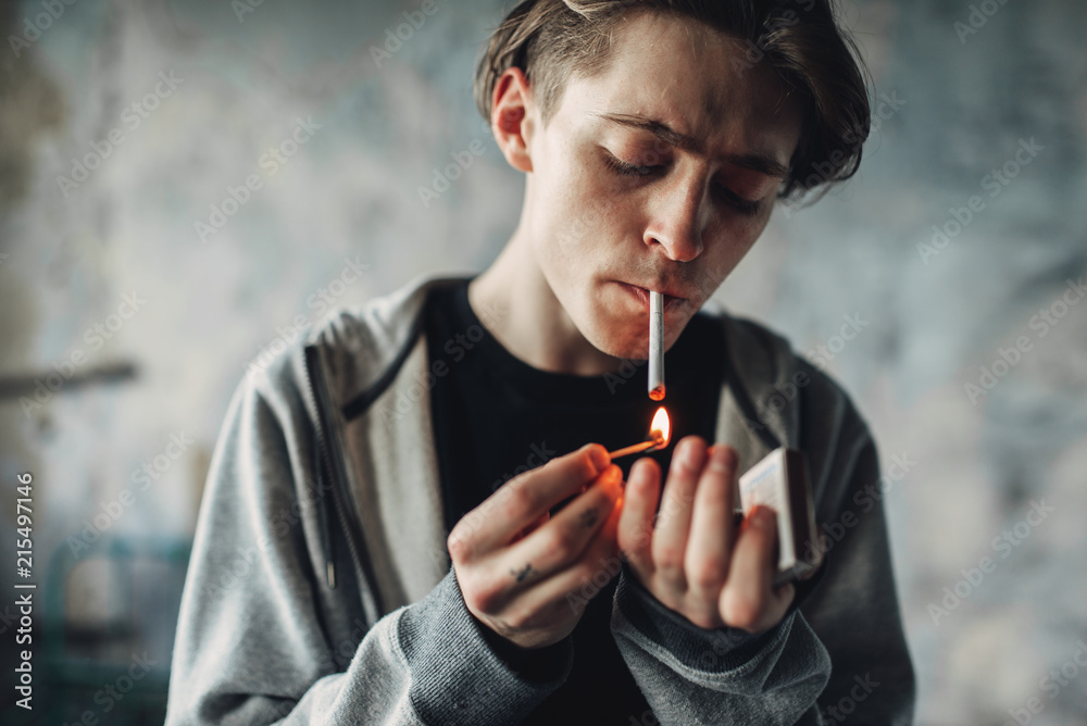 cigarette addict Male drug addict light a cigarette Stock Photo