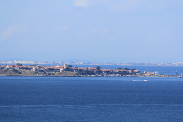 Wall Mural - blue sea and sky, a view of the coastal strip with houses and beaches