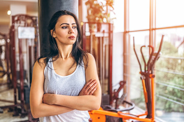 Wall Mural - Sporty girl near punching bag in the gym