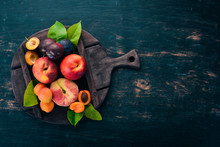Fresh Fruits. Apricot, Peach, Plums, Nectarines. On A Wooden Background. Top View. Free Space For Your Text.
