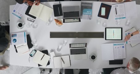 Wall Mural - time lapse diverse marketing research team brainstorming ideas on successful business solution planning strategy using colorful note paper in modern boardroom top view track