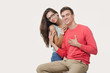 © Leika production - Happy lovely couple hugging and smiling looking at camera on white background