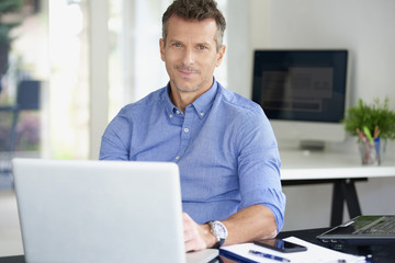 Businessman working on laptop at the office