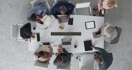 Wall Mural - time lapse diverse marketing research team brainstorming ideas on successful business solution planning strategy using colorful note paper in modern boardroom top view