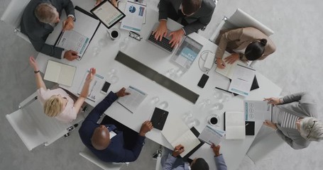 Wall Mural - professional business people meeting in boardroom multi ethnic corporate leaders collaborating sharing ideas planning strategy using tablet pc overhead