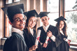 © HBS - Successful careers - here we come!Group of smiling college graduates standing together in university and smiling looking at camera.