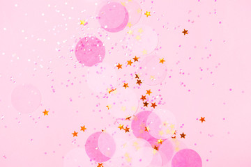 Wall Mural - Pink confetti and stars and sparkles on pink background.