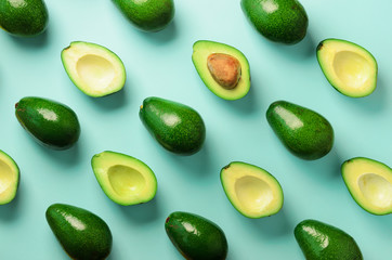Wall Mural - avocado pattern on blue background. top view. banner. pop art design, creative summer food concept. 