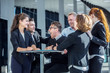 © alotofpeople - Business people congratulating coworker
