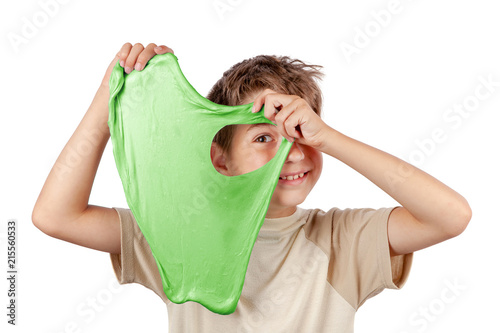 Cuadros en Lienzo Cheerful boy holding a slime and looking throw its hole